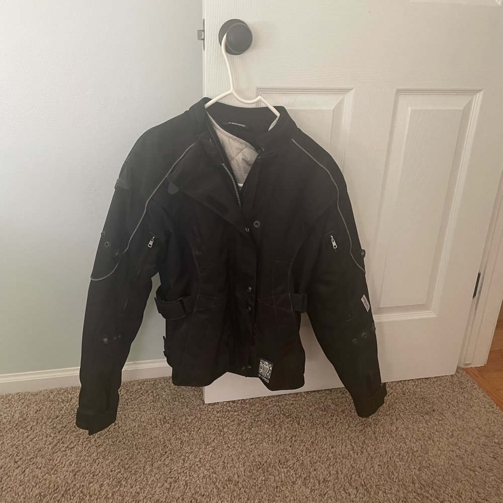 Women's black motorcycle jacket by Teknic..